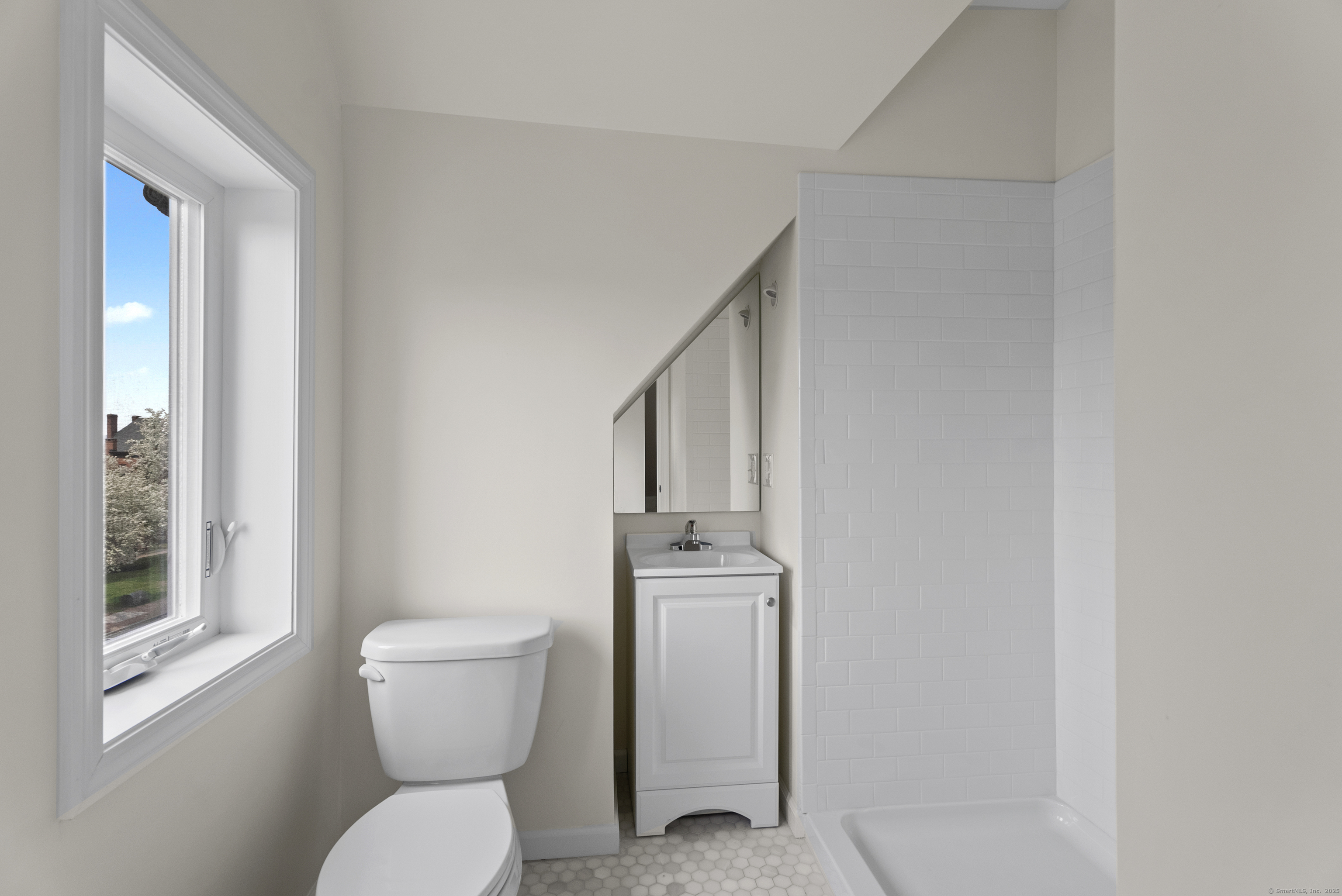 72 South Main Street, Unit 3A Wallingford, CT 06492 - Photo 11 of 14 a bathroom with a toilet a sink and window