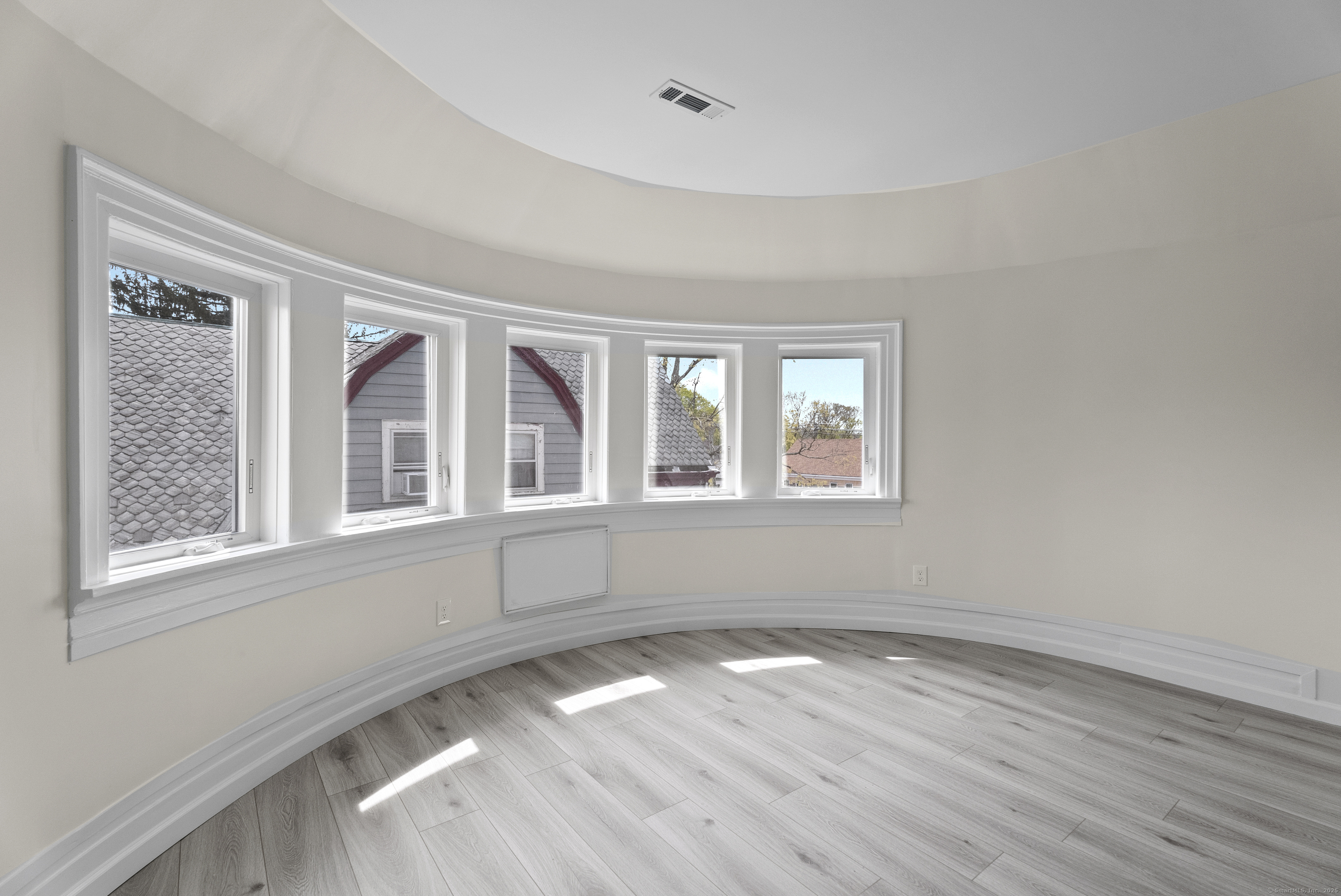 72 South Main Street, Unit 3A Wallingford, CT 06492 - Photo 3 of 14 a view of empty room with wooden floor and fan