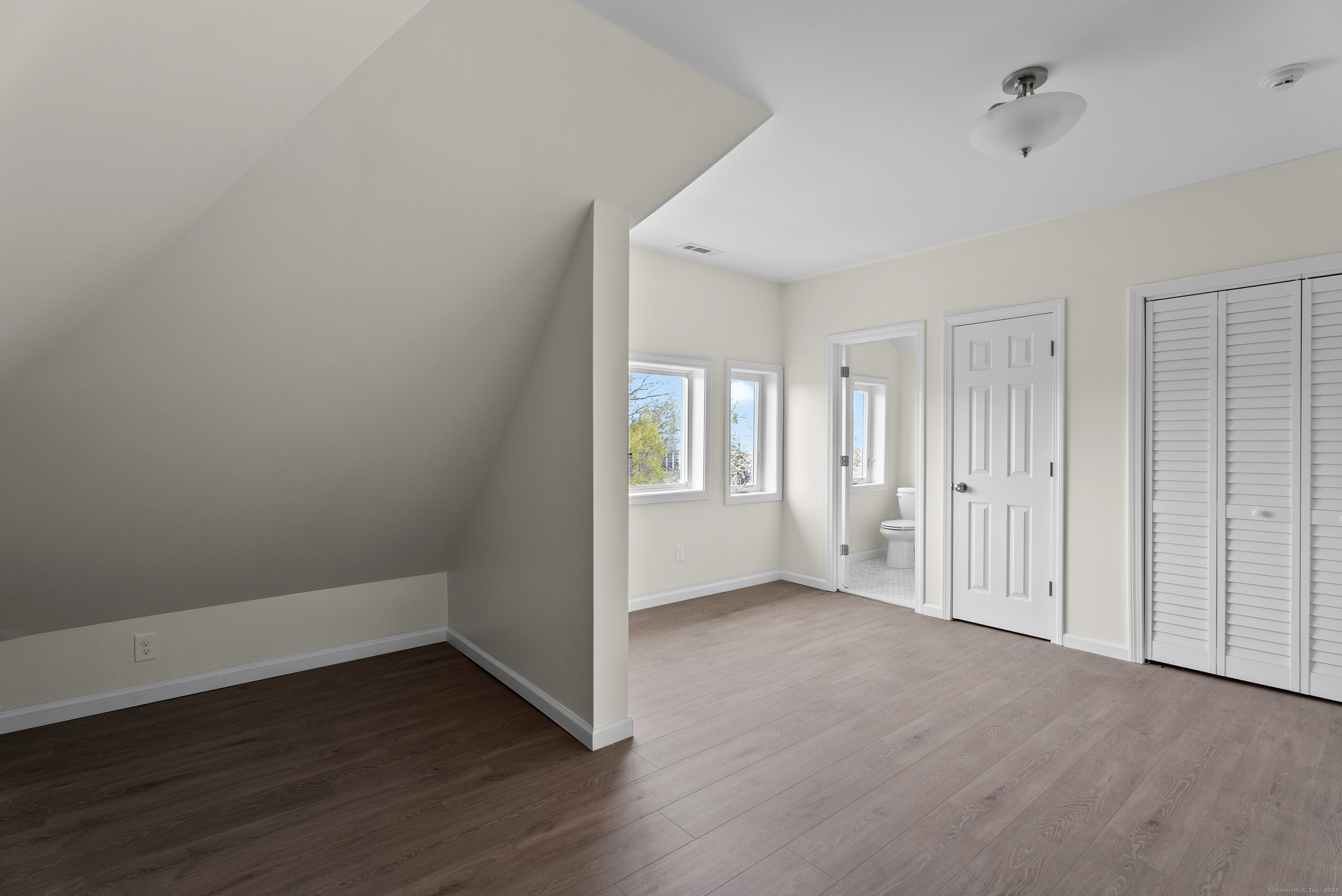 72 South Main Street, Unit 3A Wallingford, CT 06492 - Photo 8 of 14 a view of an empty room with wooden floor and a window