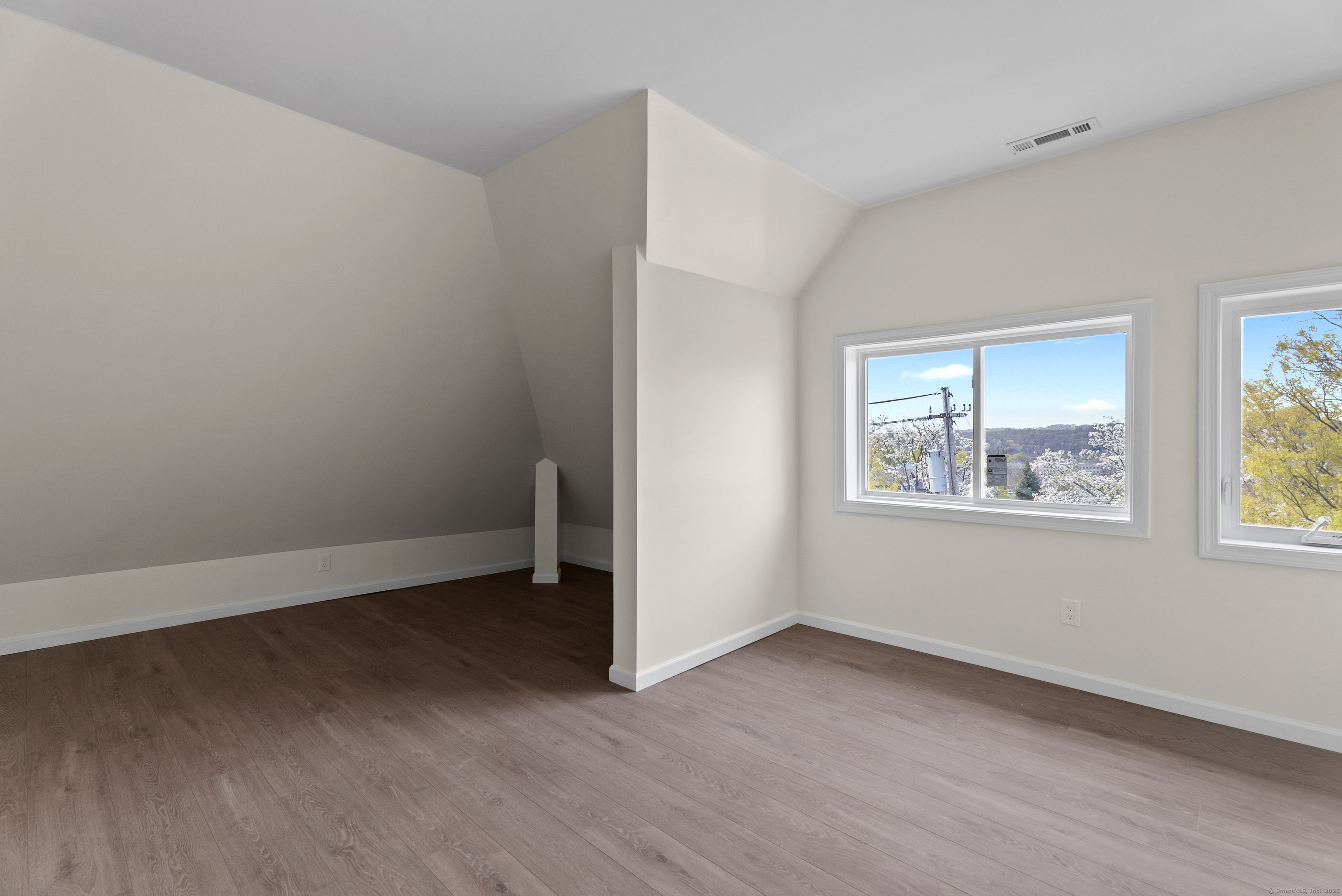 72 South Main Street, Unit 3A Wallingford, CT 06492 - Photo 9 of 14 an empty room with wooden floor and windows