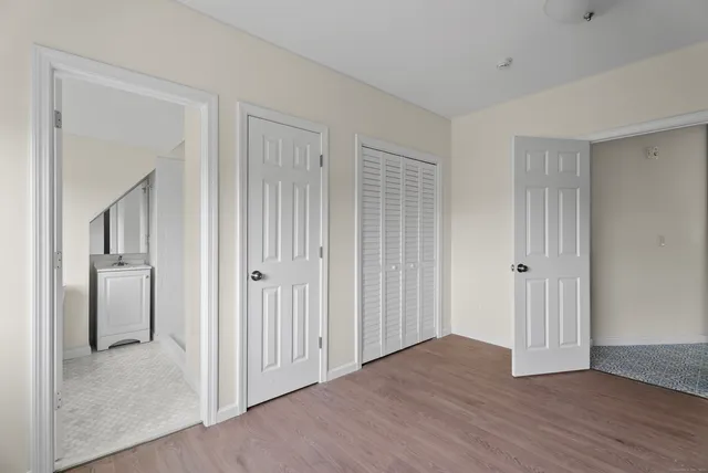 a view of a hallway with wooden floor