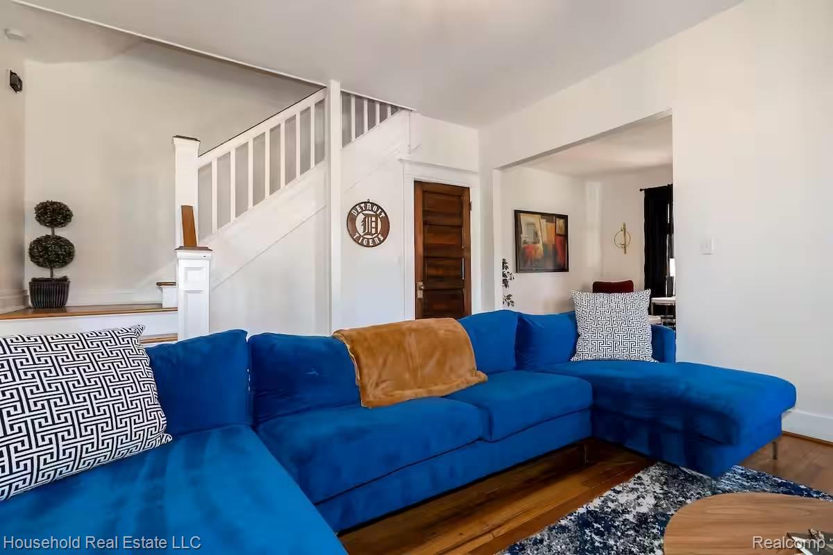 4446 Commonwealth Street Detroit, MI 48208 - Photo 23 of 28 Living room featuring wood finished floors and stairway