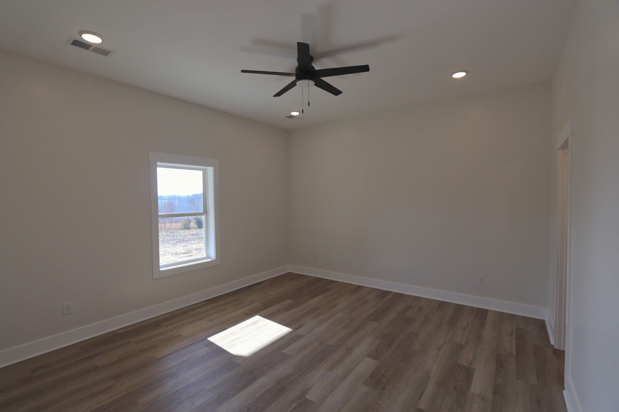 2679 Dotson Road Lafayette, TN 37083 - Photo 12 of 25 an empty room with wooden floor and windows
