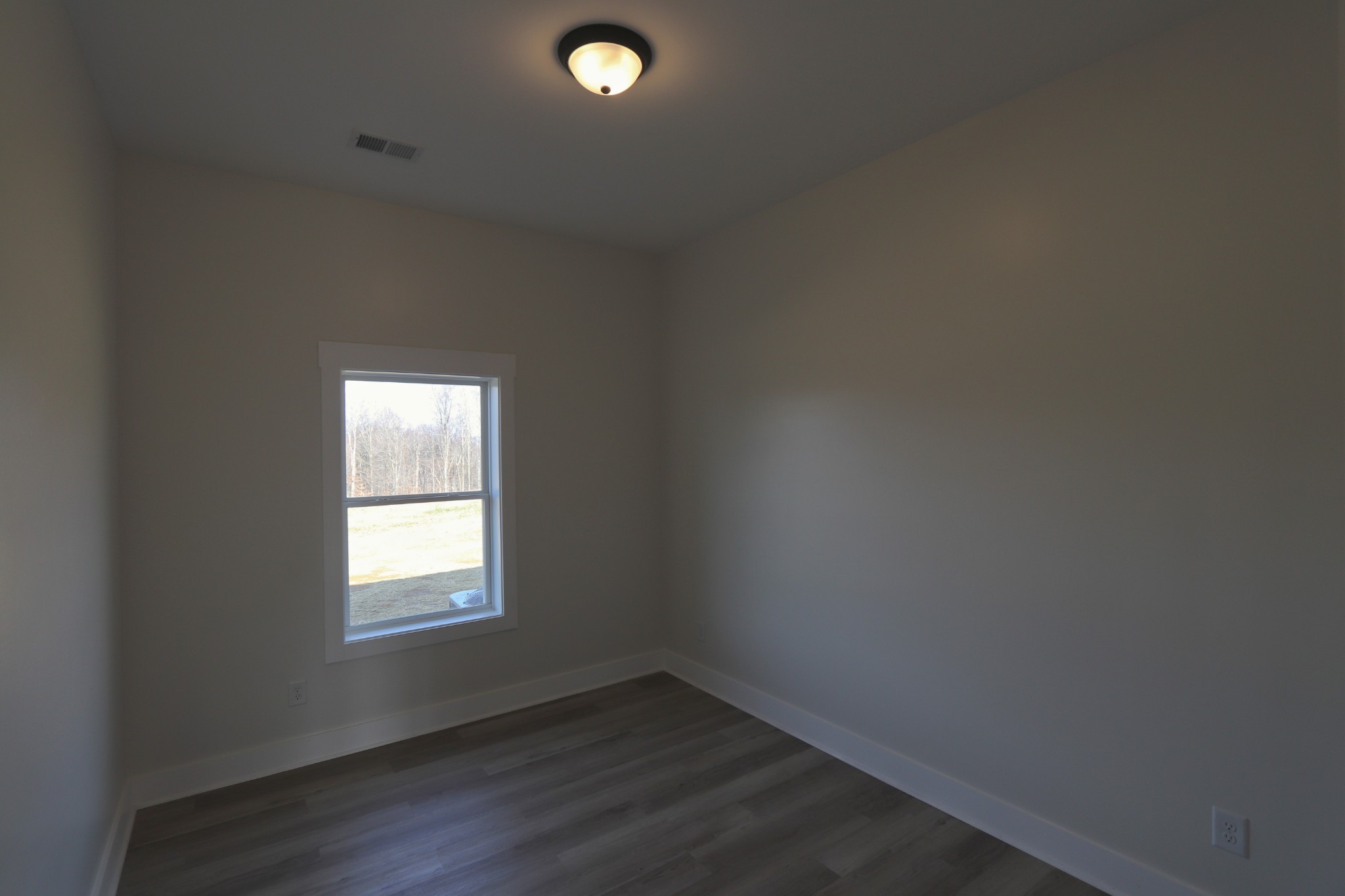 2679 Dotson Road Lafayette, TN 37083 - Photo 17 of 25 an empty room with wooden floor and windows