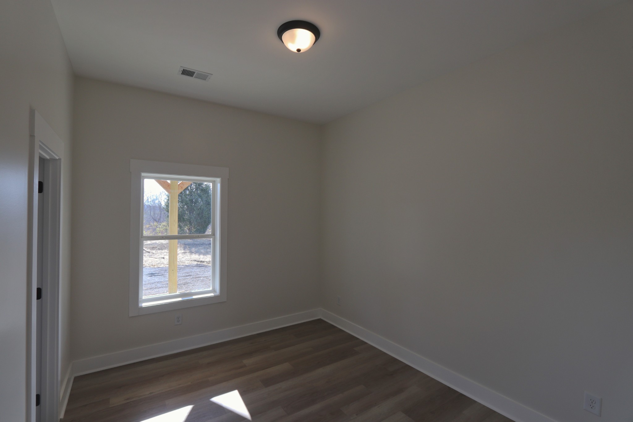2679 Dotson Road Lafayette, TN 37083 - Photo 18 of 25 an empty room with wooden floor and windows