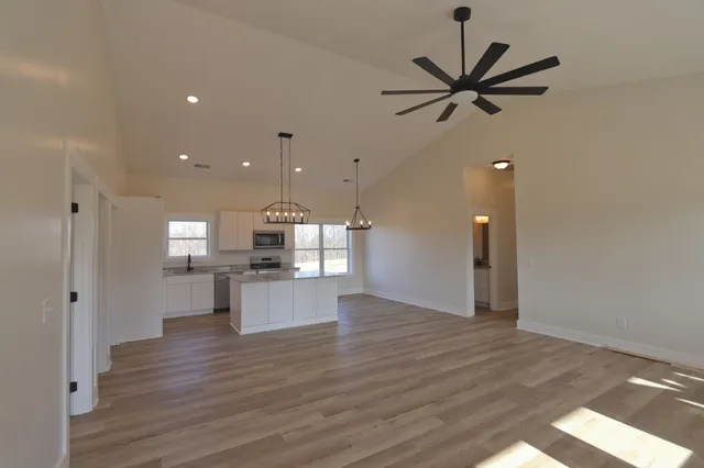 a open kitchen with white cabinets and stainless steel appliances