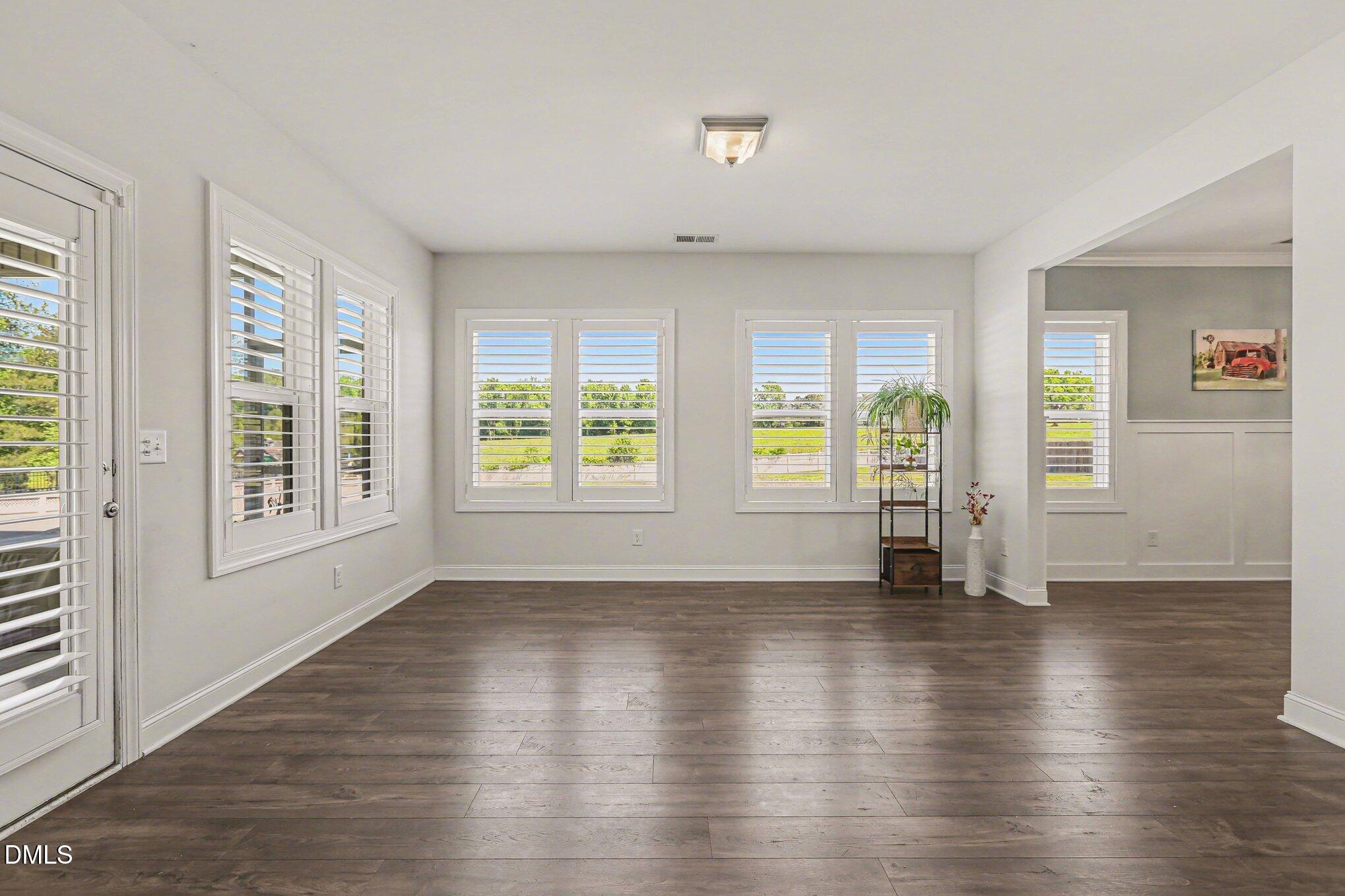 432 Seabring Lane Raleigh, NC 27603 - Photo 14 of 29 an empty room with wooden floor and windows
