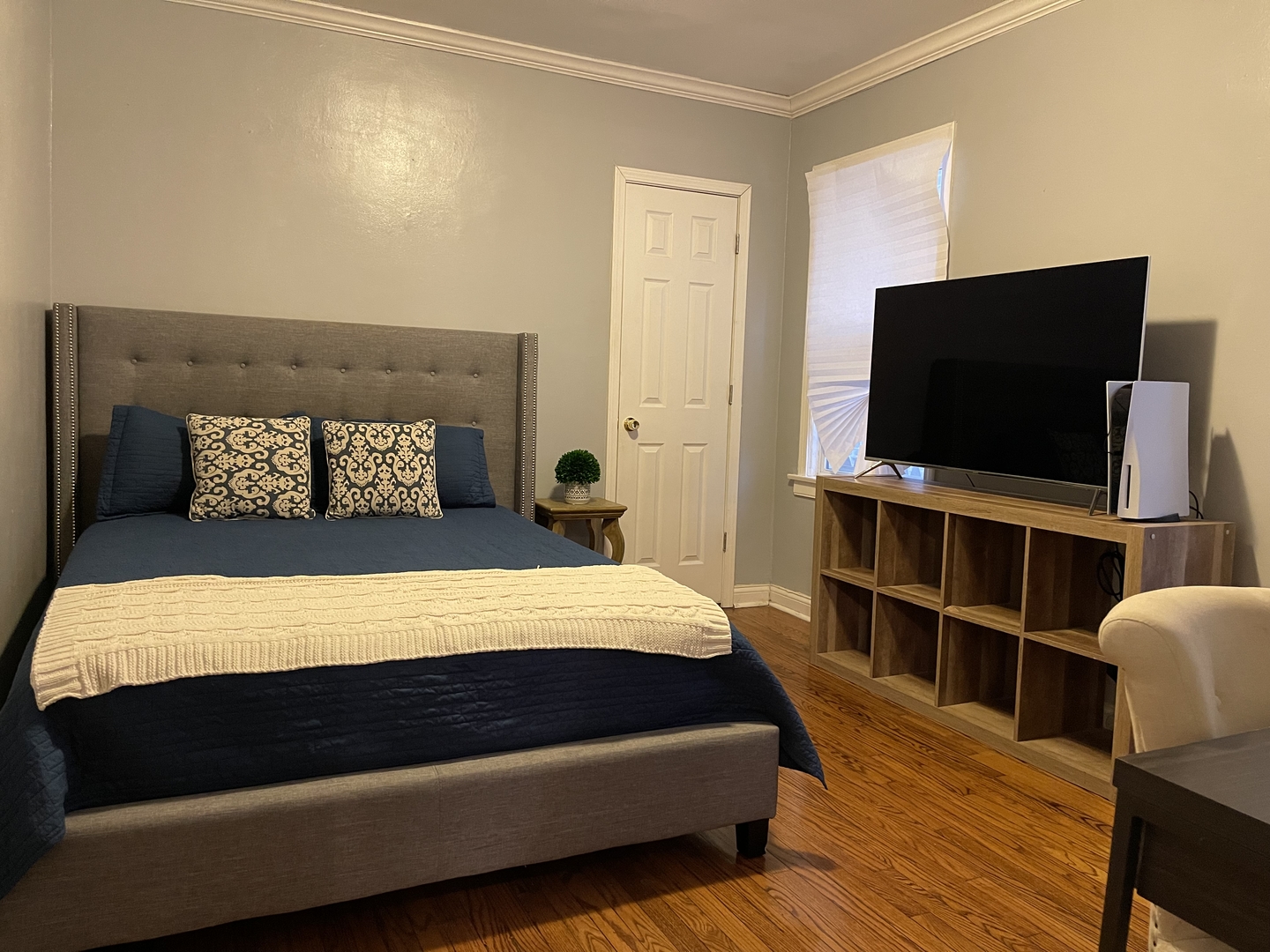 10441 South Prairie Avenue Chicago, IL 60628 - Photo 13 of 36 a bedroom with a bed and a flat screen tv