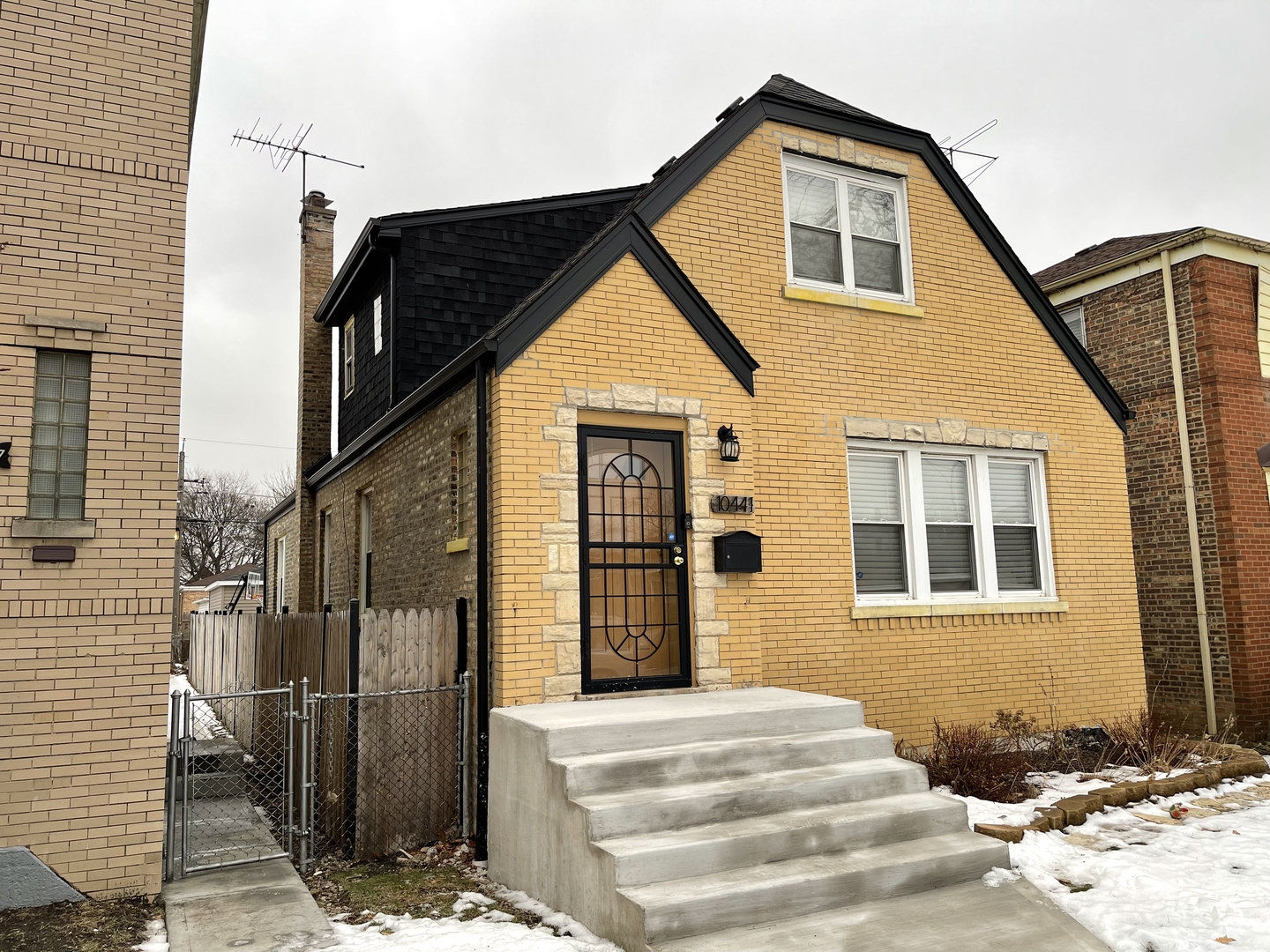 10441 South Prairie Avenue Chicago, IL 60628 - Photo 3 of 36 a view of a brick house with many windows
