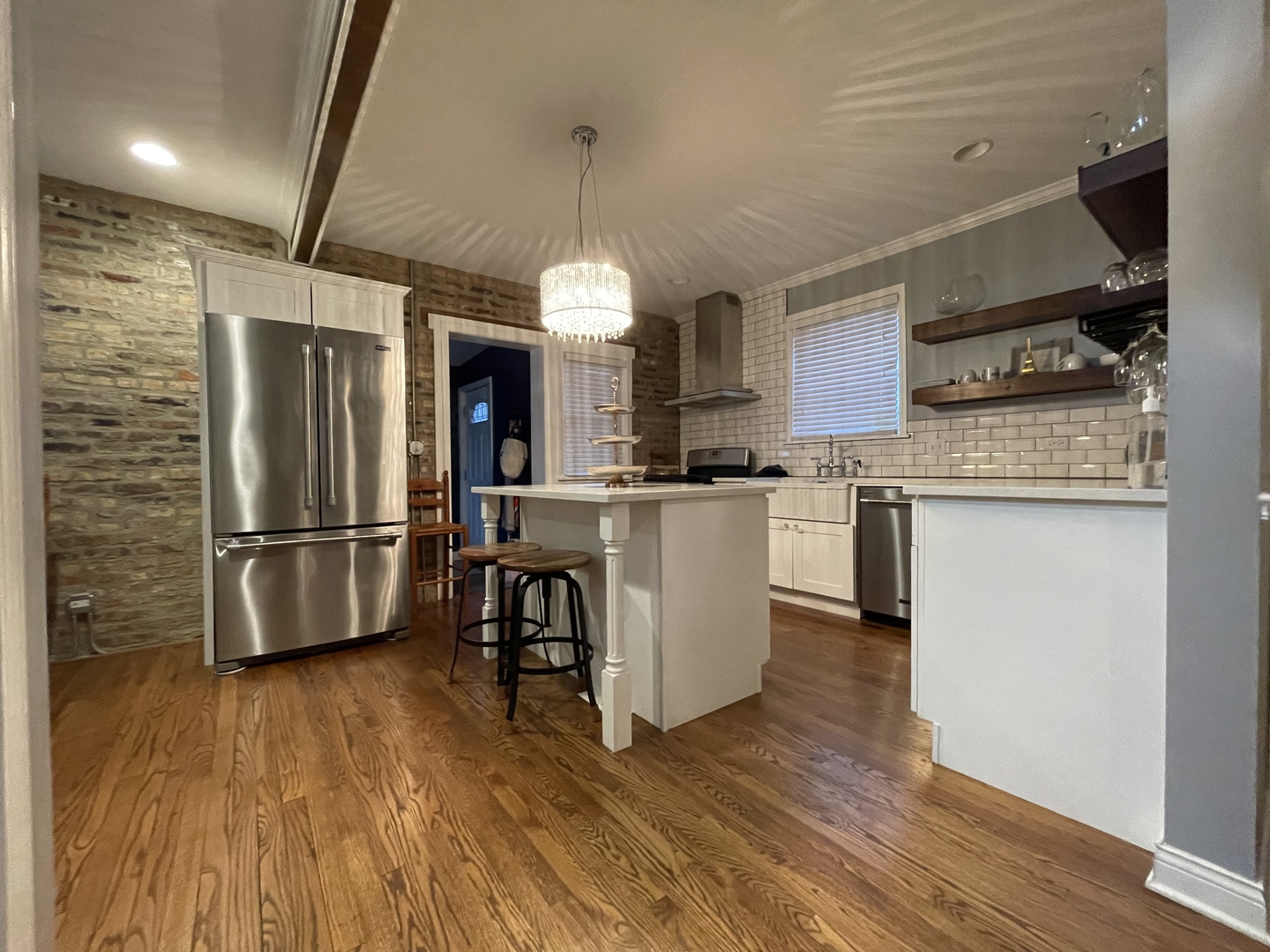 10441 South Prairie Avenue Chicago, IL 60628 - Photo 4 of 36 a kitchen with stainless steel appliances wooden floor and large counter top space