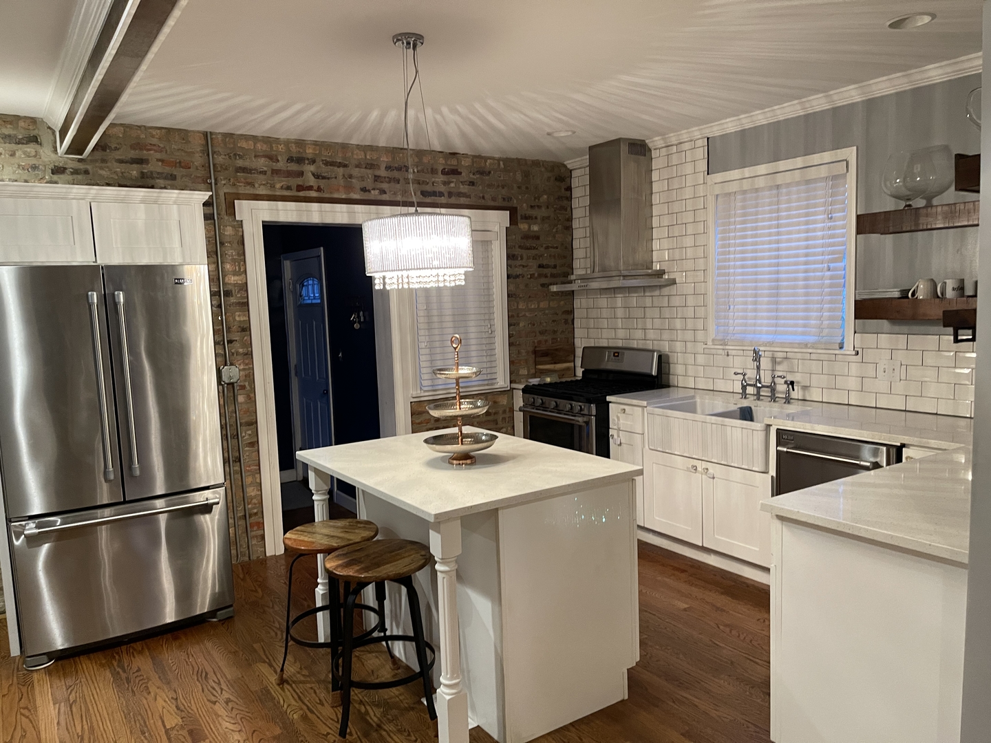 10441 South Prairie Avenue Chicago, IL 60628 - Photo 5 of 36 a kitchen with stainless steel appliances wooden floor and sink
