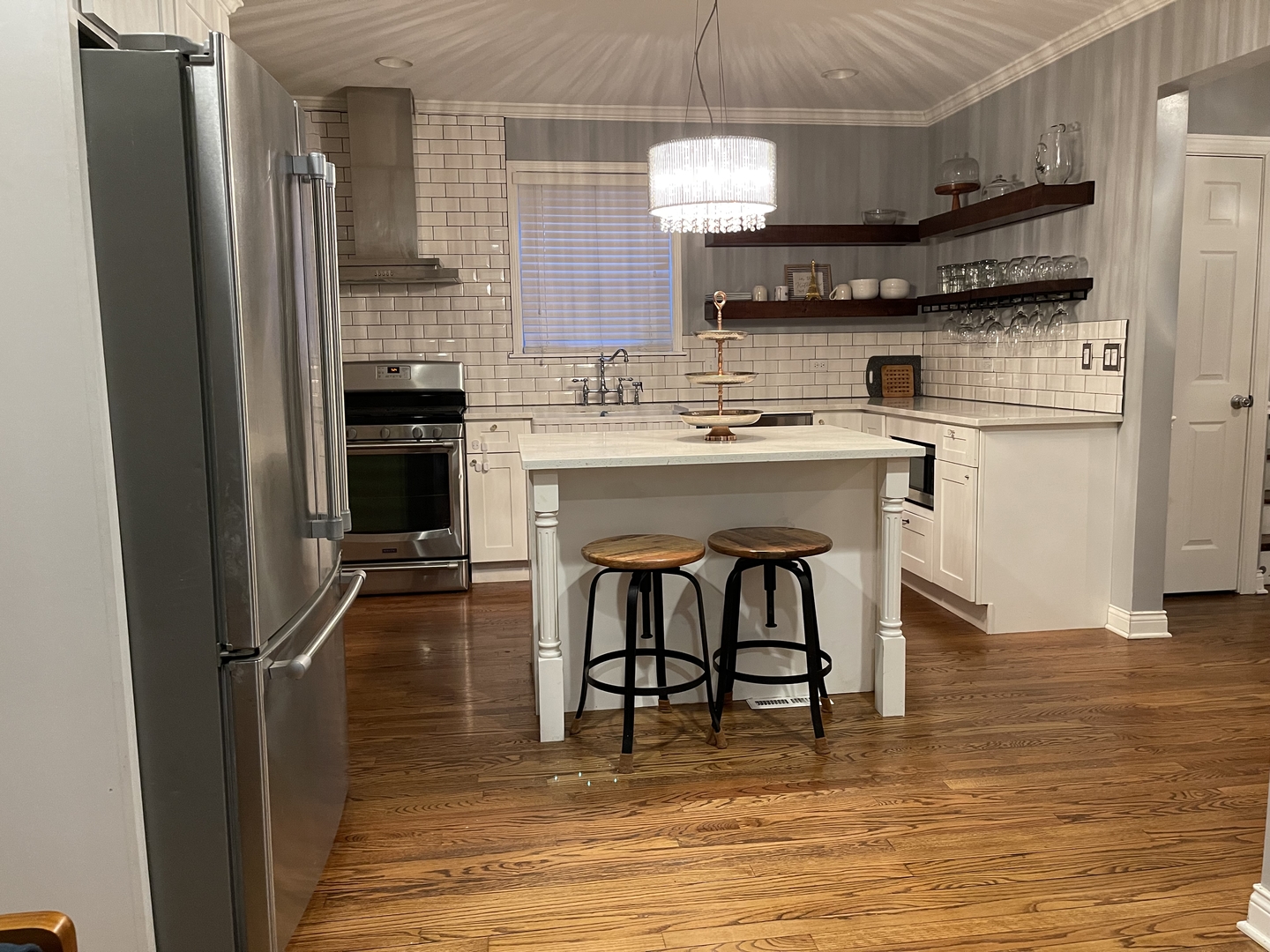 10441 South Prairie Avenue Chicago, IL 60628 - Photo 7 of 36 a kitchen with stainless steel appliances a sink a stove a refrigerator and cabinets