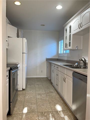 a kitchen with a refrigerator sink and stove