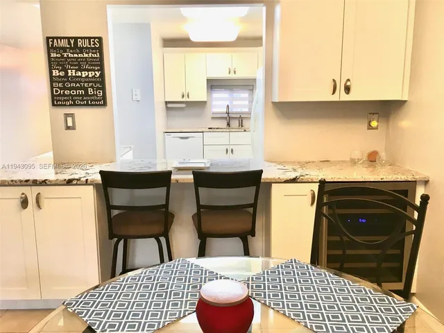 a kitchen with a sink cabinets and a table