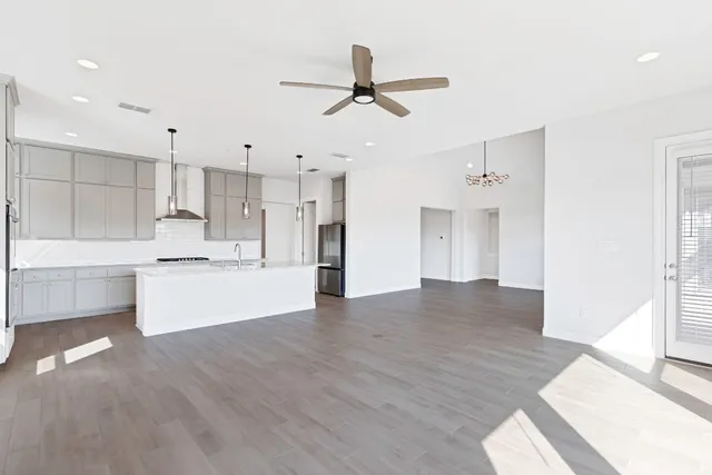 a view of a kitchen with wooden floor and a sink