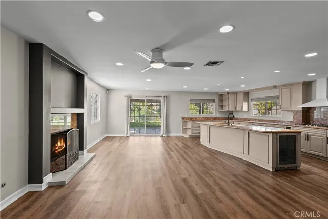 a open kitchen with stove top oven and refrigerator