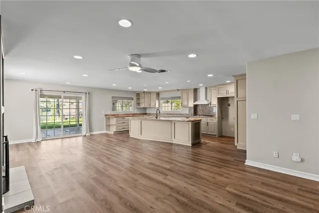 a view of kitchen dining table kitchen island and stainless steel appliances