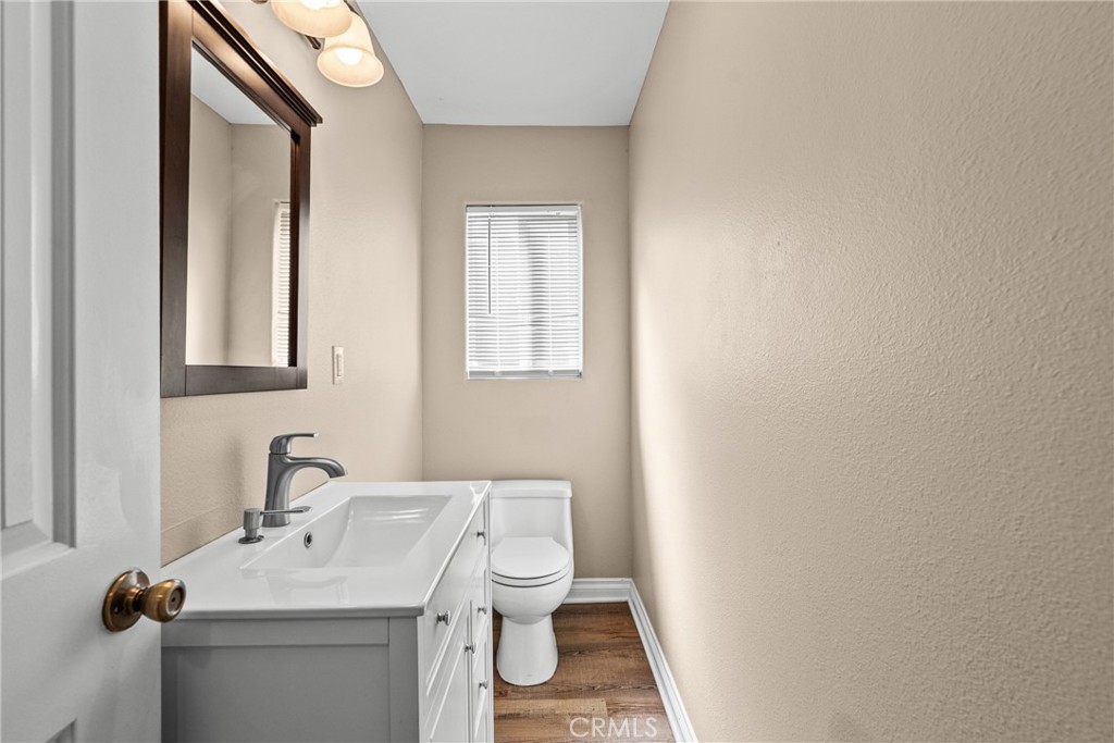 19573 Pine Valley Avenue Porter Ranch, CA 91326 - Photo 21 of 48 a bathroom with a sink toilet and mirror