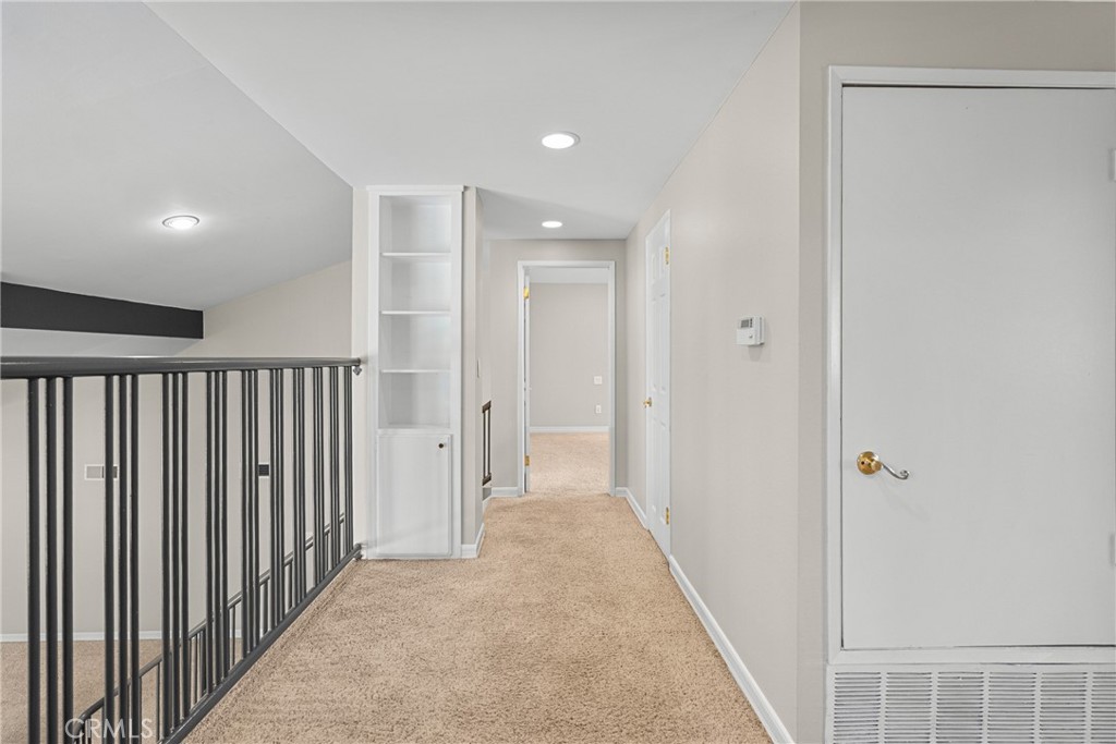 19573 Pine Valley Avenue Porter Ranch, CA 91326 - Photo 23 of 48 a view of a hallway with wooden floor