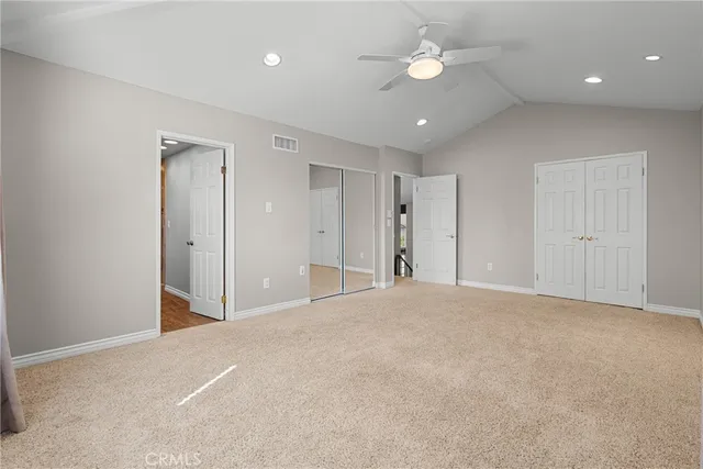a view of an empty room with a ceiling fan