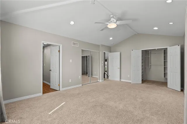 a view of an empty room with a ceiling fan