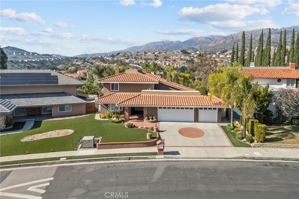 19573 Pine Valley Avenue Porter Ranch, CA 91326 - Photo 3 of 48 a front view of a house with a garden and plants