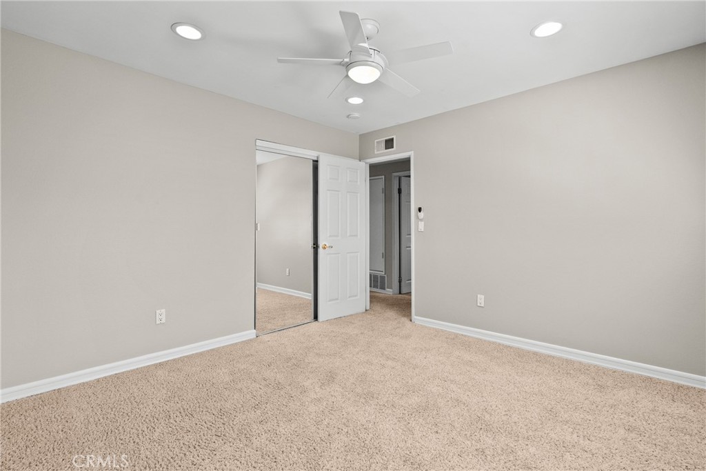 19573 Pine Valley Avenue Porter Ranch, CA 91326 - Photo 31 of 48 an empty room with a ceiling fan and closet