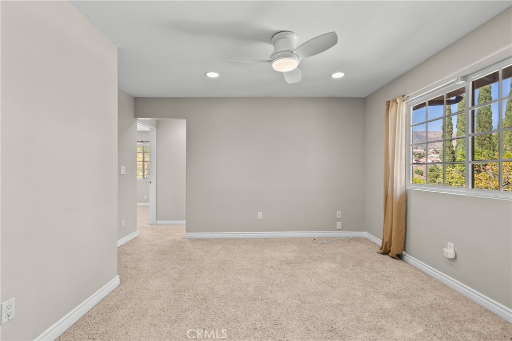 19573 Pine Valley Avenue Porter Ranch, CA 91326 - Photo 33 of 48 an empty room with wooden floor and windows