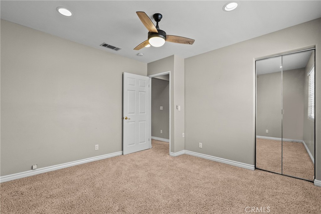 19573 Pine Valley Avenue Porter Ranch, CA 91326 - Photo 35 of 48 an empty room with closet and windows