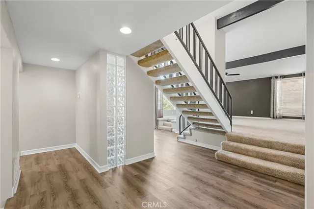 a view of entryway and hall with wooden floor
