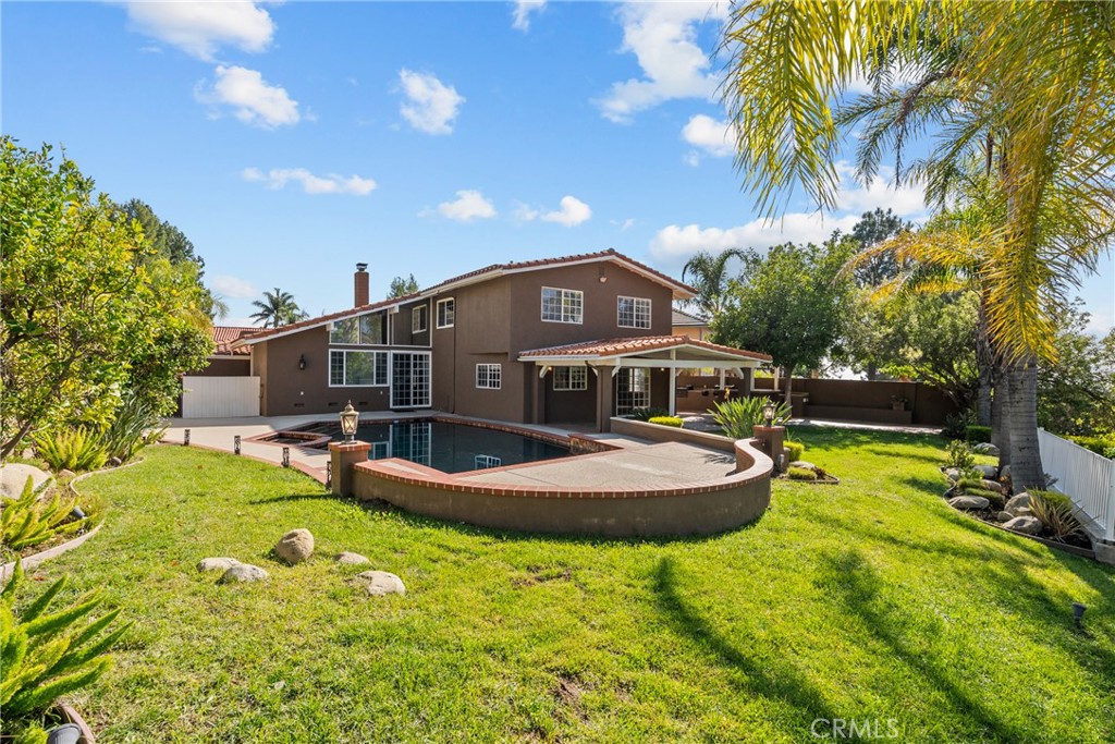 19573 Pine Valley Avenue Porter Ranch, CA 91326 - Photo 43 of 48 a front view of a house with swimming pool and porch