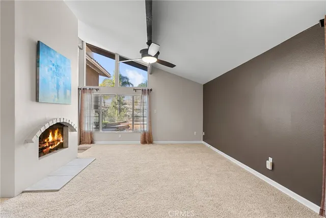 an empty room with windows and ceiling fan