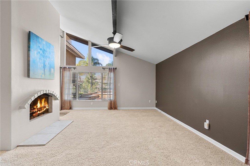 19573 Pine Valley Avenue Porter Ranch, CA 91326 - Photo 5 of 48 an empty room with windows and ceiling fan