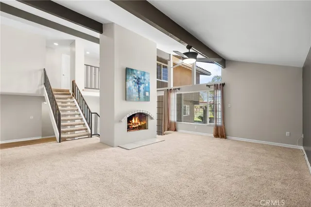a view of a livingroom with wooden floor and a ceiling fan
