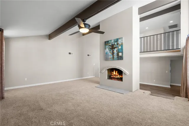 an empty room with ceiling fan and window