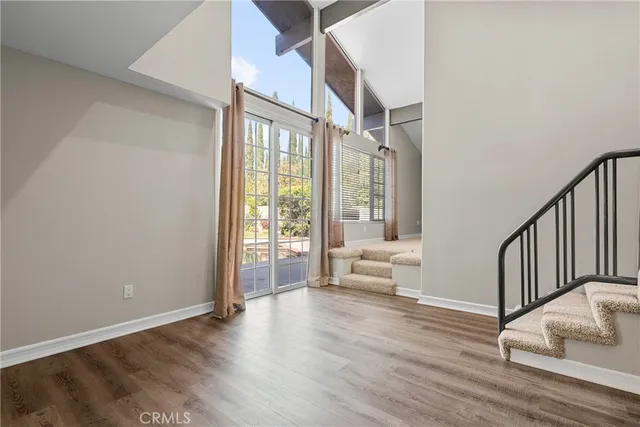 a view of an entryway with wooden floor and a livingroom