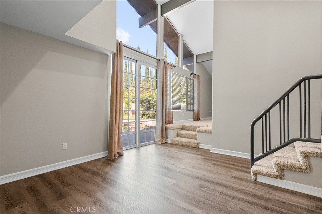 19573 Pine Valley Avenue Porter Ranch, CA 91326 - Photo 9 of 48 a view of an entryway with wooden floor and a livingroom