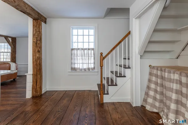 a view of entryway with wooden floor and stairs