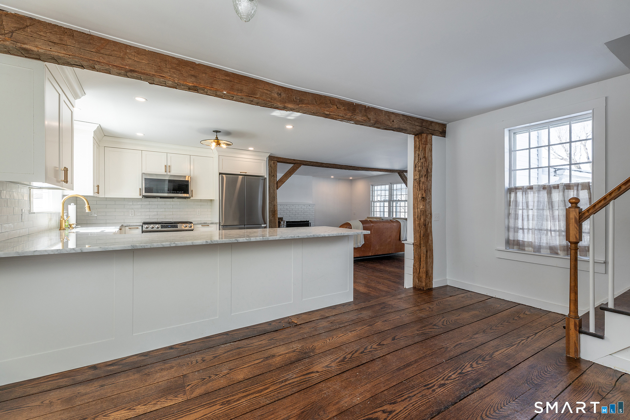 403 Beach Street Litchfield, CT 06759 - Photo 11 of 34 a large white kitchen with wooden floor and a window