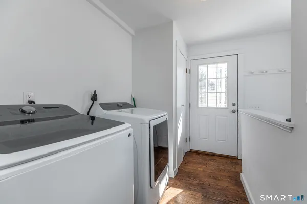 a bathroom with a granite countertop sink a large mirror a and a window