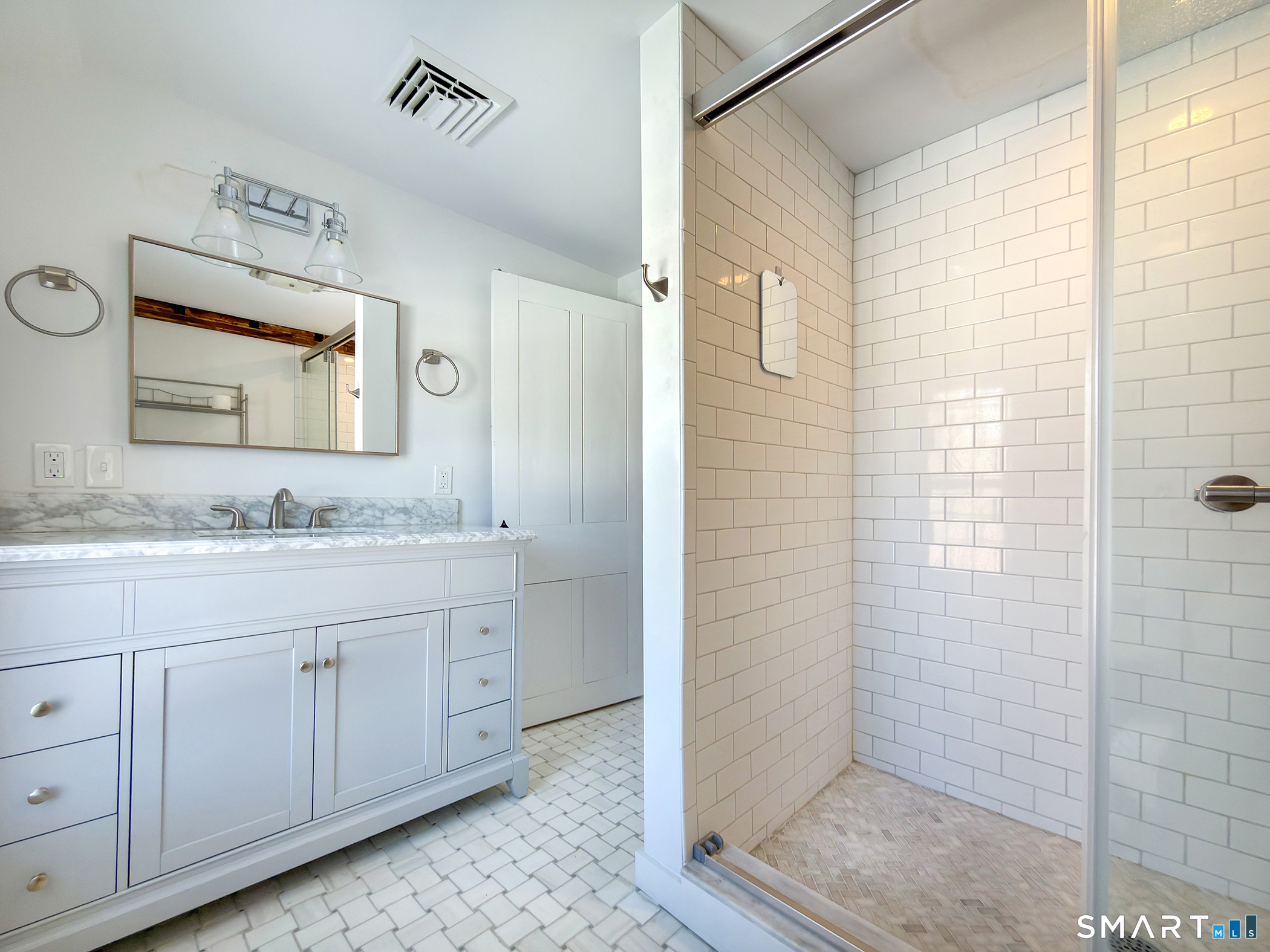 403 Beach Street Litchfield, CT 06759 - Photo 28 of 34 a bathroom with a granite countertop sink a mirror and shower
