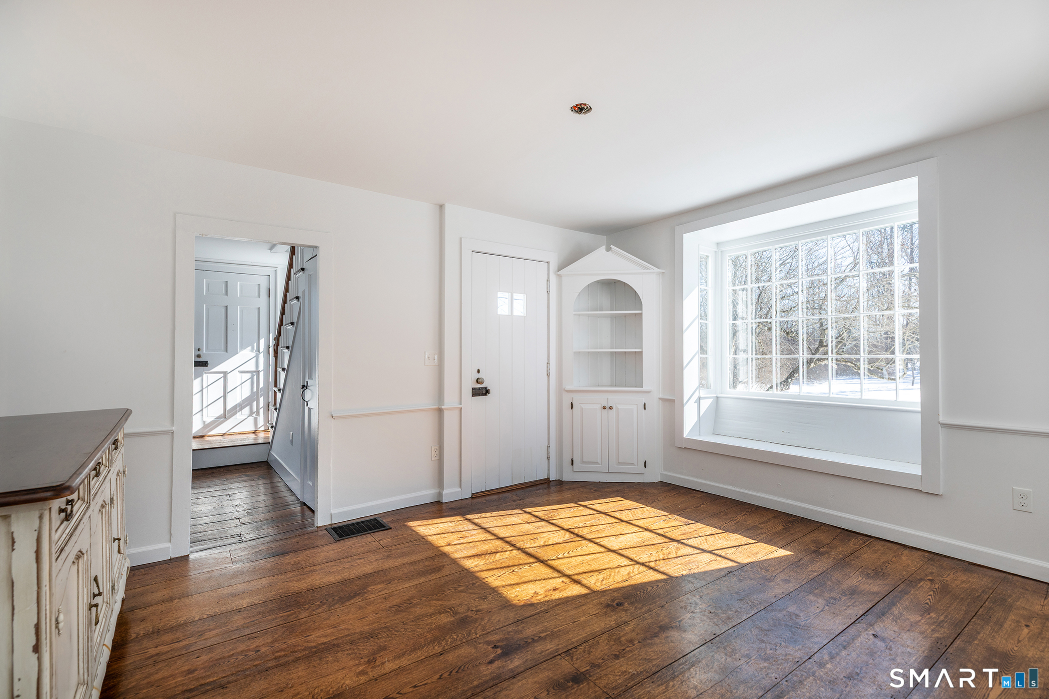 403 Beach Street Litchfield, CT 06759 - Photo 8 of 33 an empty room with wooden floor and windows