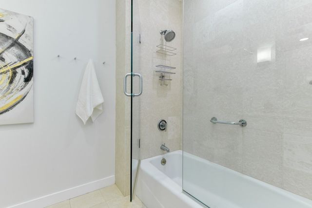 a bathroom with a bathtub and shower