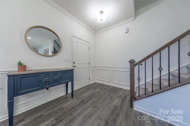 a view of a hallway with wooden floor and entryway