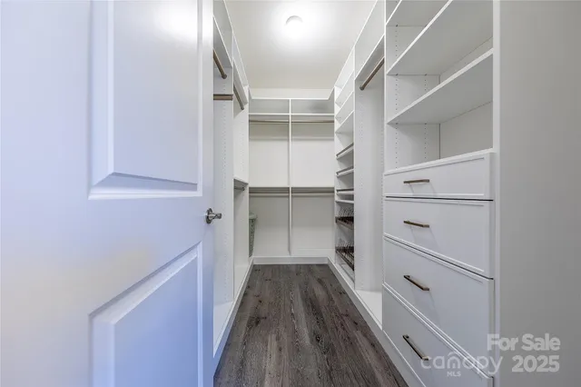 a view of hallway with stairs and wooden floor