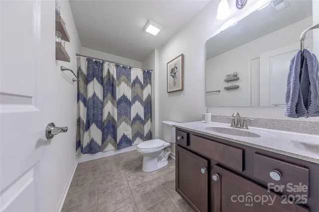 a bedroom with a bed cabinets and a window