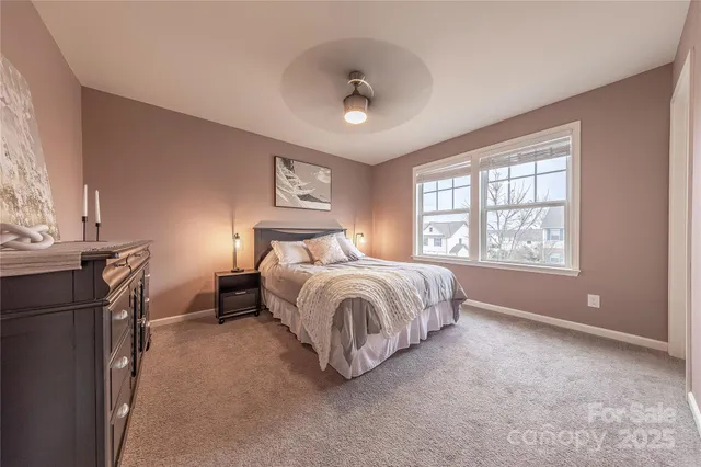 a view of a livingroom with furniture and a ceiling fan