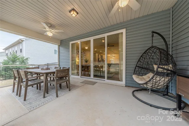 a backyard of a house with table and chairs
