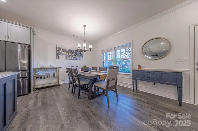 a view of a dining room with furniture and chandelier