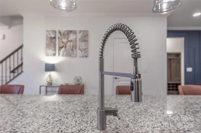 a kitchen with a dining table chairs wooden floor appliances and cabinets